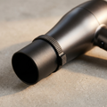 SmoothShot black matte anti-frizz nozzle concentrator attachment on hair dryer dramatic close-up on concrete surface
